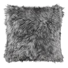 a gray furry pillow on a white background