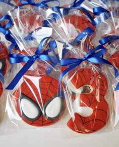 spiderman cookies wrapped in plastic and tied with blue ribbon