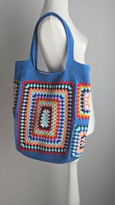 a crocheted bag on a mannequin head