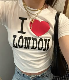 a woman taking a selfie in the mirror wearing a t - shirt that says i love london