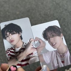 two people holding up polaroids with one person's hand on the other