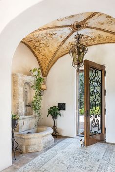 the entrance to a home with an ornate archway