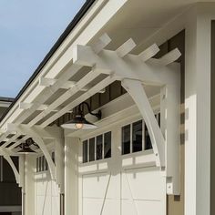 a white garage with a ceiling fan on it's side and attached to the roof