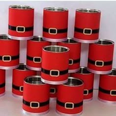 a bunch of red and black boxes with gold buckles on each one in the middle