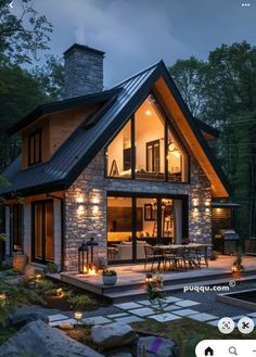 an image of a house that is lit up in the evening with lights on it