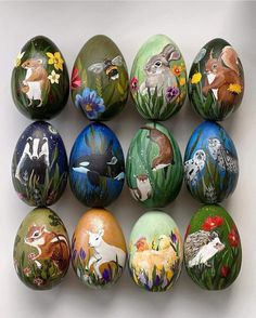 an assortment of painted eggs with animals on them