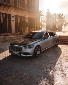 a silver car parked in front of a building