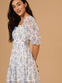 The Maddy Floral Mini Dress features a charming white and blue floral print with short sleeves, lace trim, and a cute tie-front detail. This feminine design combines a delicate, romantic look with a flattering, breezy silhouette. Swimwear Trends, Romantic Look, Feminine Design, Shop Maxi Dresses, Cute Fits, Floral Mini Dress, Sweater Shop