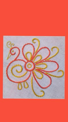 a close up of a piece of cloth with an embroidered flower design on the side