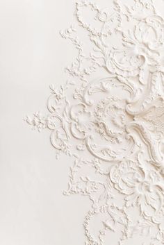 an intricately designed wallpaper with white paint