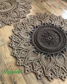 two crocheted doily on the floor, one is brown