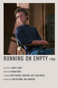 a man sitting in a chair with his arms crossed and the words running on empty above him