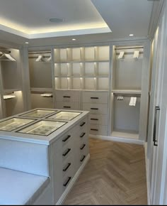 an empty walk in closet with lots of drawers