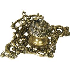 an ornate brass candle holder on a white background