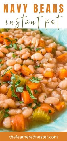 a bowl filled with beans and carrots on top of a blue plate next to a spoon