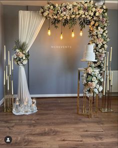 a wedding arch with flowers and candles