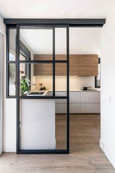 an open kitchen and living room with sliding glass doors