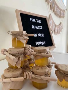 honey jars are stacked on top of each other and labeled for the rummy in your tummy