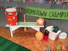 there is a bench with basketballs and other sports items on the floor next to it