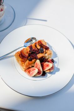 a white plate topped with fruit covered in sauce