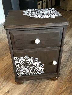 a brown and white painted wooden cabinet with drawers