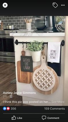 kitchen utensils and cutting boards are hanging on the wall in front of the stove