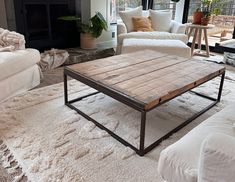 a living room filled with furniture and a fire place in the middle of the room