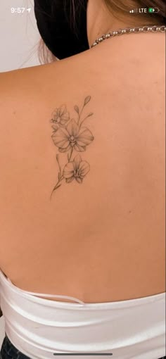 a woman with a flower tattoo on her back