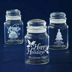 three glass jars with christmas designs on them