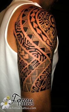 a man's arm with an intricate tattoo design on the upper half of his arm