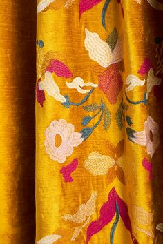 yellow fabric with flowers and leaves on it