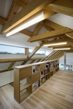 an empty room with wooden beams and bookshelves