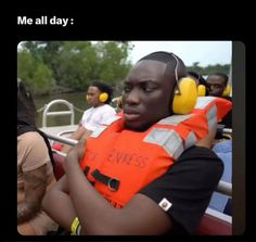 a man in an orange life vest listening to headphones