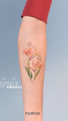 a woman's leg with tattoos on her legs and flowers in the middle of it