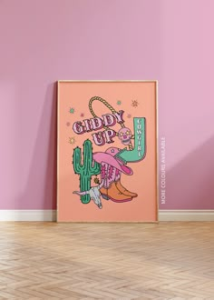 a pink wall with a cactus and cowboy boots on it, next to a poster that says candy up