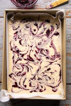 a pan filled with batter and toppings on top of a wooden table