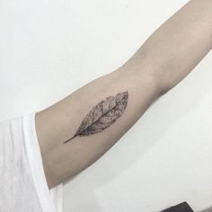 a single leaf tattoo on the arm