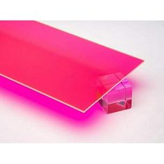 a pink rectangular object sitting on top of a white surface