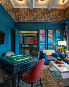 a living room filled with furniture and a pool table