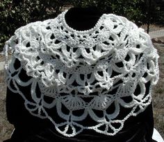 a white crocheted scarf sitting on top of a table