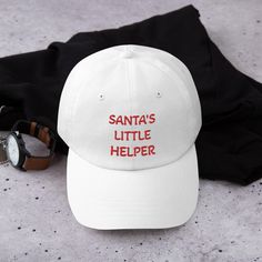 Dad hats aren't just for dads. This one's got a low profile with an adjustable strap and curved visor. Christmas spirit must have and perfect gift for hat lovers! * 100% chino cotton twill * Unstructured, 6-panel, low-profile * 6 embroidered eyelets * 3 ⅛" (7.6 cm) crown * Adjustable strap with antique buckle This product is made especially for you as soon as you place an order, which is why it takes us a bit longer to deliver it to you. Making products on demand instead of in bulk helps reduce Casual White Hat For Holiday, Casual White Holiday Hat, Casual White Christmas Hat, Customizable Dad Hat For Gift, Personalized Dad Hat Gift, White Christmas Cap, Red Christmas Cap, Adjustable Christmas Cap, Christmas Party Hat