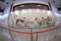 an artisticly decorated wall in the middle of a room with glass railings and flowers painted on it