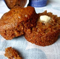 two muffins sitting on top of a blue cloth