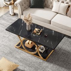 a black marble coffee table with gold accents