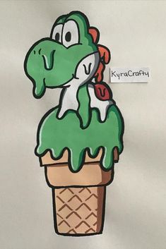 an ice cream cone with green icing and a cartoon character sticking out of it