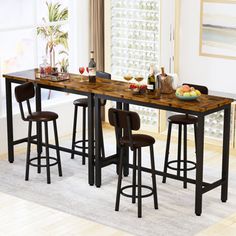 a kitchen table with four stools in front of it