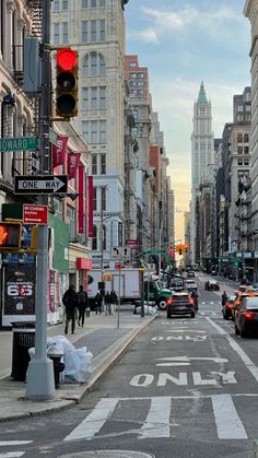 a city street filled with traffic next to tall buildings