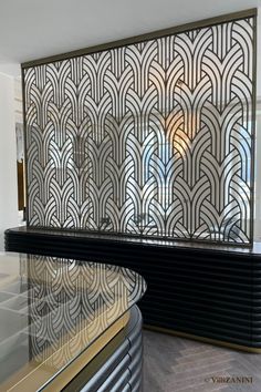 an art deco wall in the lobby of a building with glass and metal panels on it