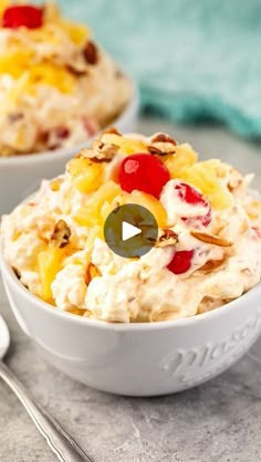 two bowls filled with fruit salad on top of a table