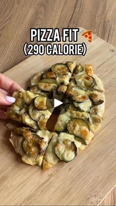 someone is cutting into a pizza on top of a wooden board with the words pizza fit 29 calories